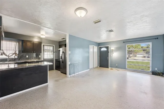 a view of a kitchen with a sink and a large window