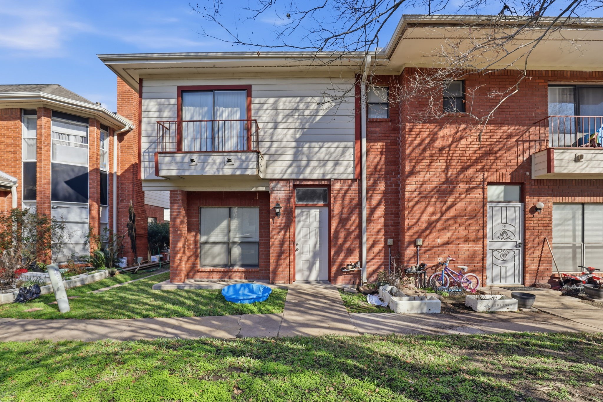 8320 Wild Rose Street, Unit 4B Houston, TX 77083 - Photo 1 of 16 a view of a building with a yard