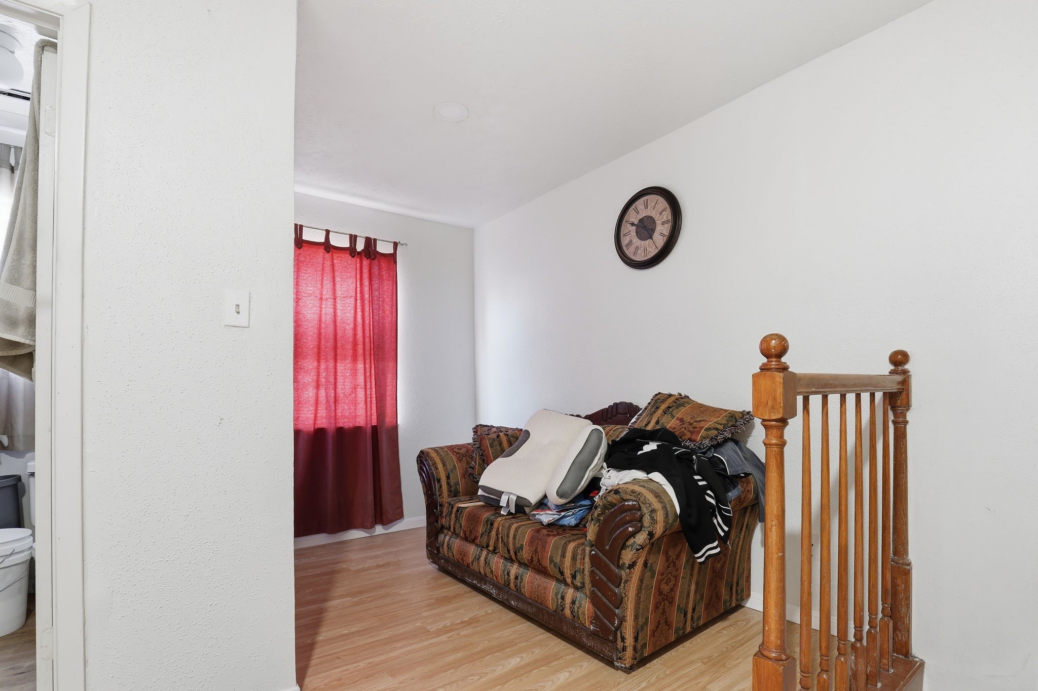 8320 Wild Rose Street, Unit 4B Houston, TX 77083 - Photo 11 of 16 a living room with furniture a window and a wooden floor