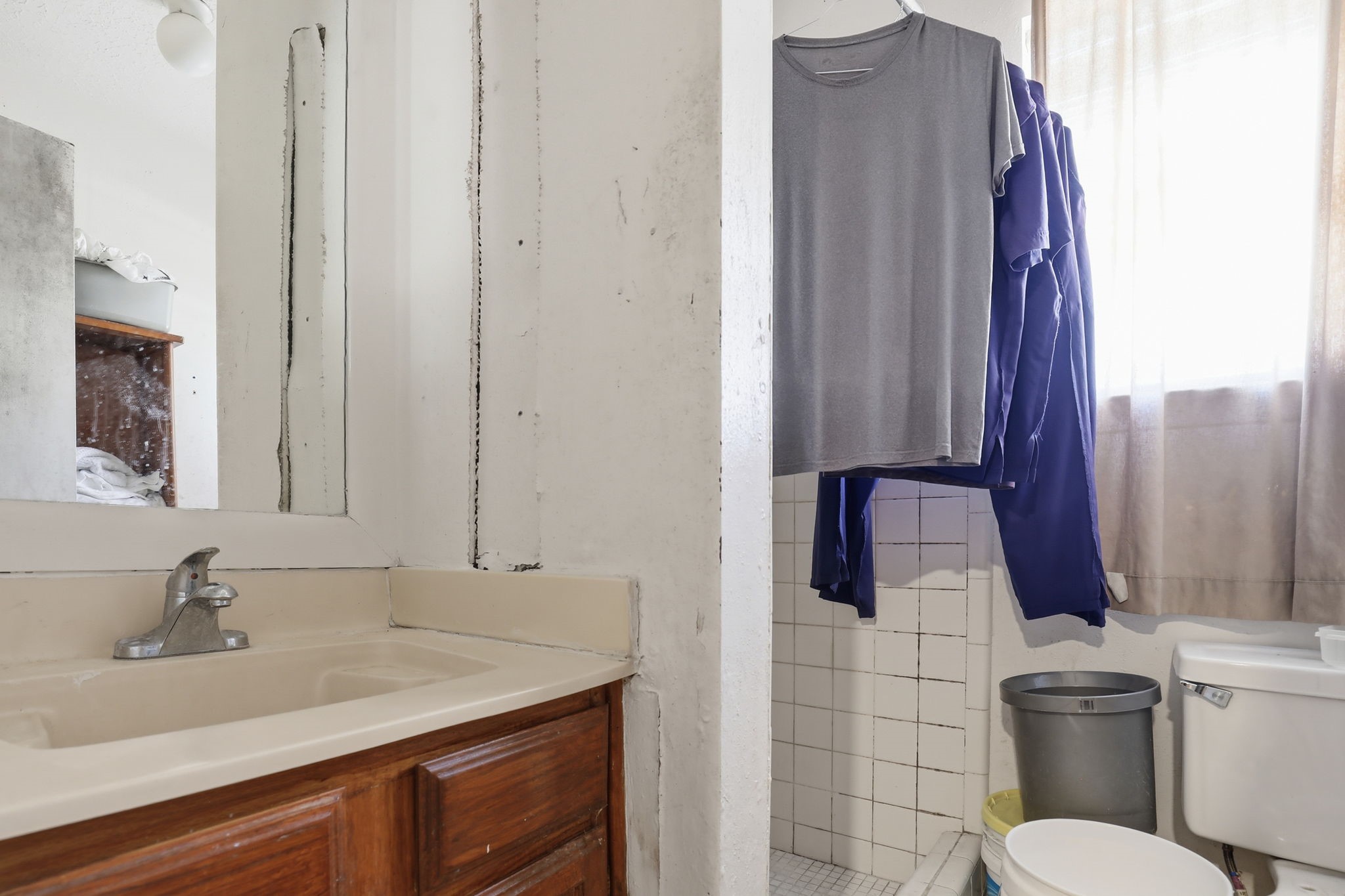 8320 Wild Rose Street, Unit 4B Houston, TX 77083 - Photo 12 of 16 a bathroom with a granite countertop sink toilet and mirror