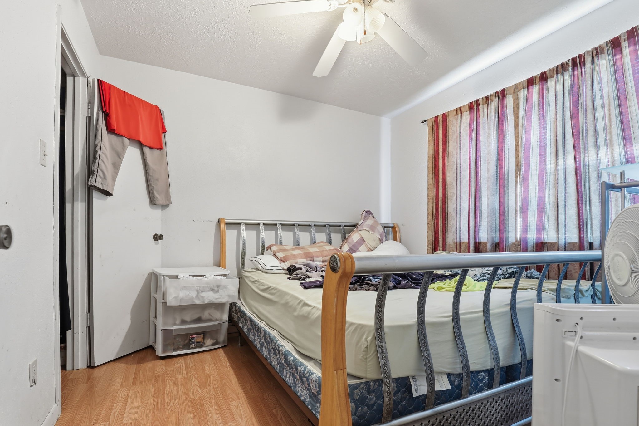 8320 Wild Rose Street, Unit 4B Houston, TX 77083 - Photo 13 of 16 a bed room with furniture and a window
