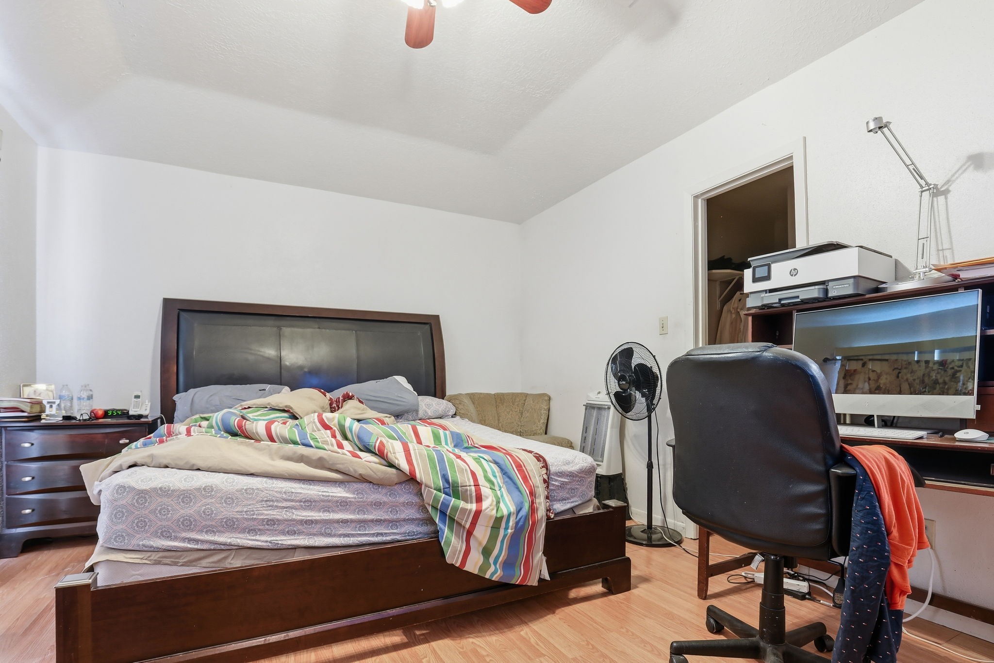 8320 Wild Rose Street, Unit 4B Houston, TX 77083 - Photo 15 of 16 a bedroom with a bed and a flat screen tv