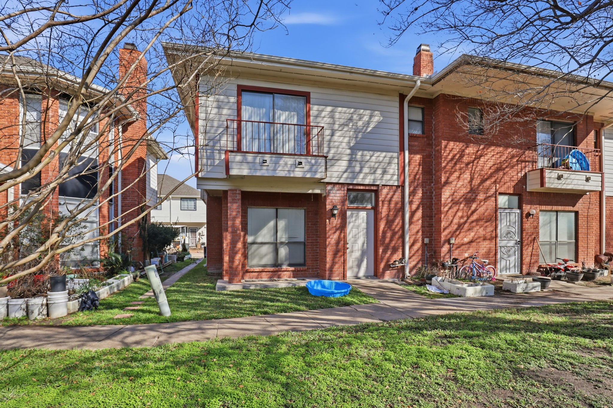 8320 Wild Rose Street, Unit 4B Houston, TX 77083 - Photo 2 of 16 a view of a building with a yard