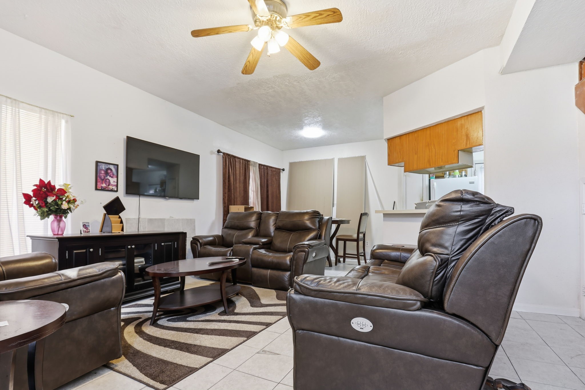 8320 Wild Rose Street, Unit 4B Houston, TX 77083 - Photo 3 of 16 a living room with furniture and a flat screen tv