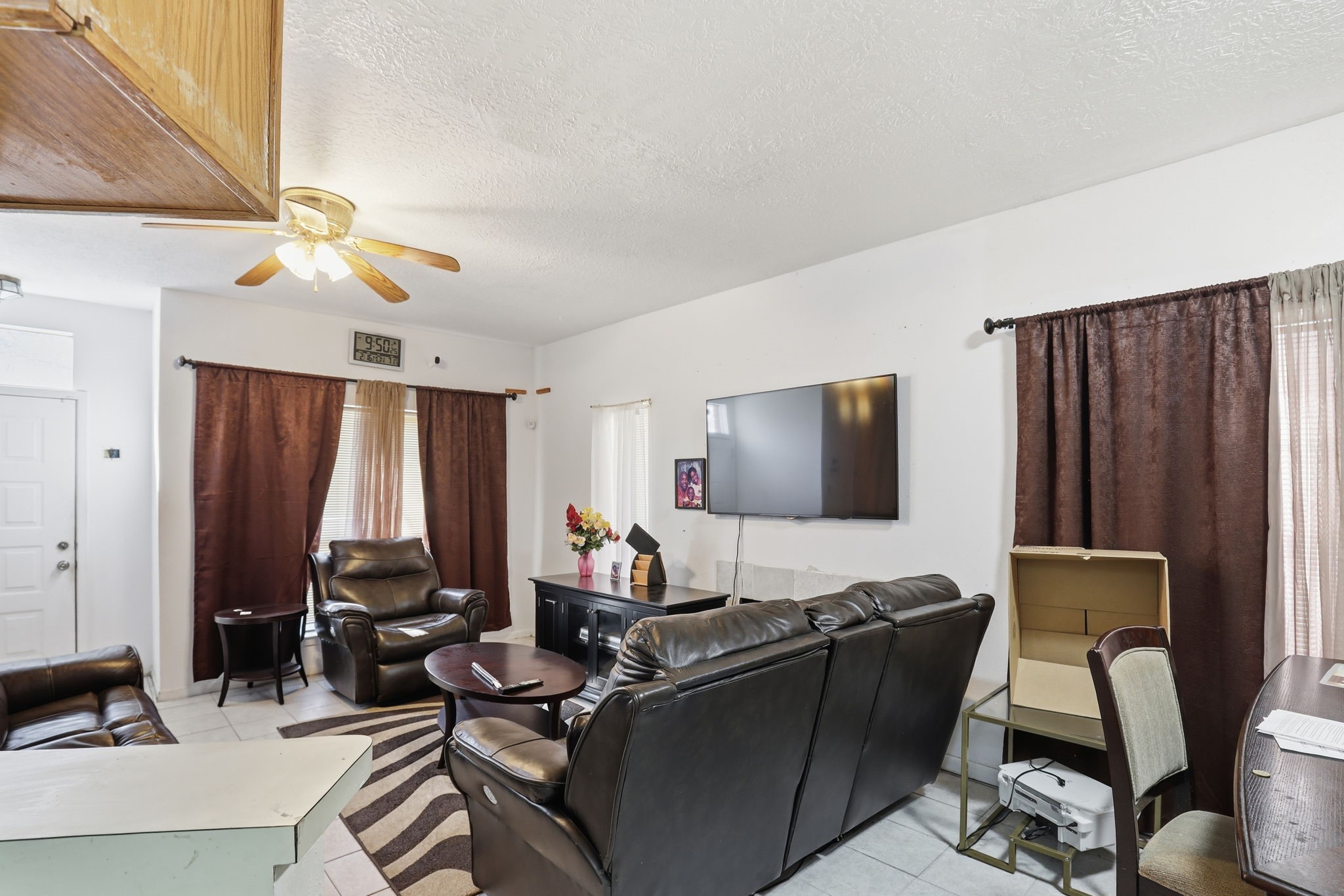 8320 Wild Rose Street, Unit 4B Houston, TX 77083 - Photo 7 of 16 a work room with furniture and a flat screen tv