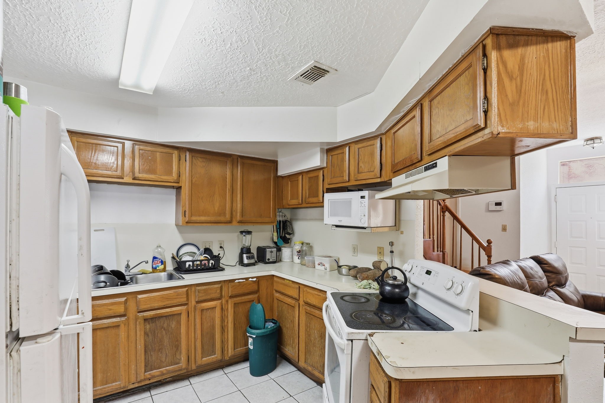 8320 Wild Rose Street, Unit 4B Houston, TX 77083 - Photo 9 of 16 a kitchen with stainless steel appliances granite countertop a sink and cabinets