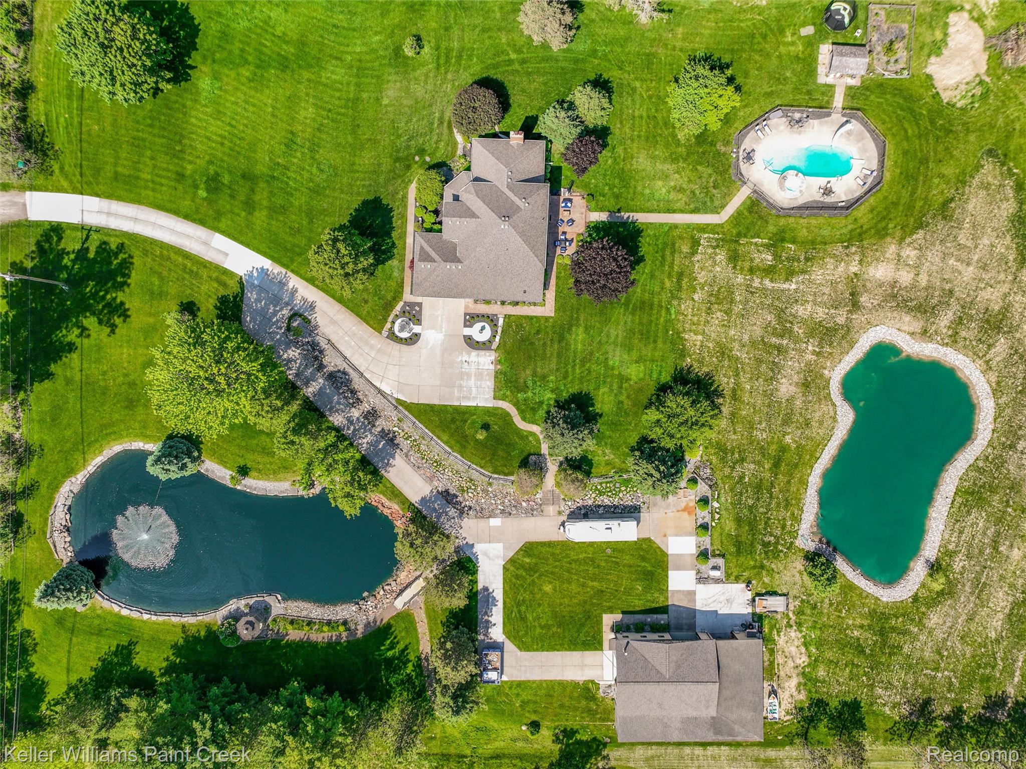 5813 36 Mile Road Romeo, MI 48065 - Photo 74 of 81 Expansive property featuring a main residence, two distinct ponds, a large swimming pool, and a secondary structure