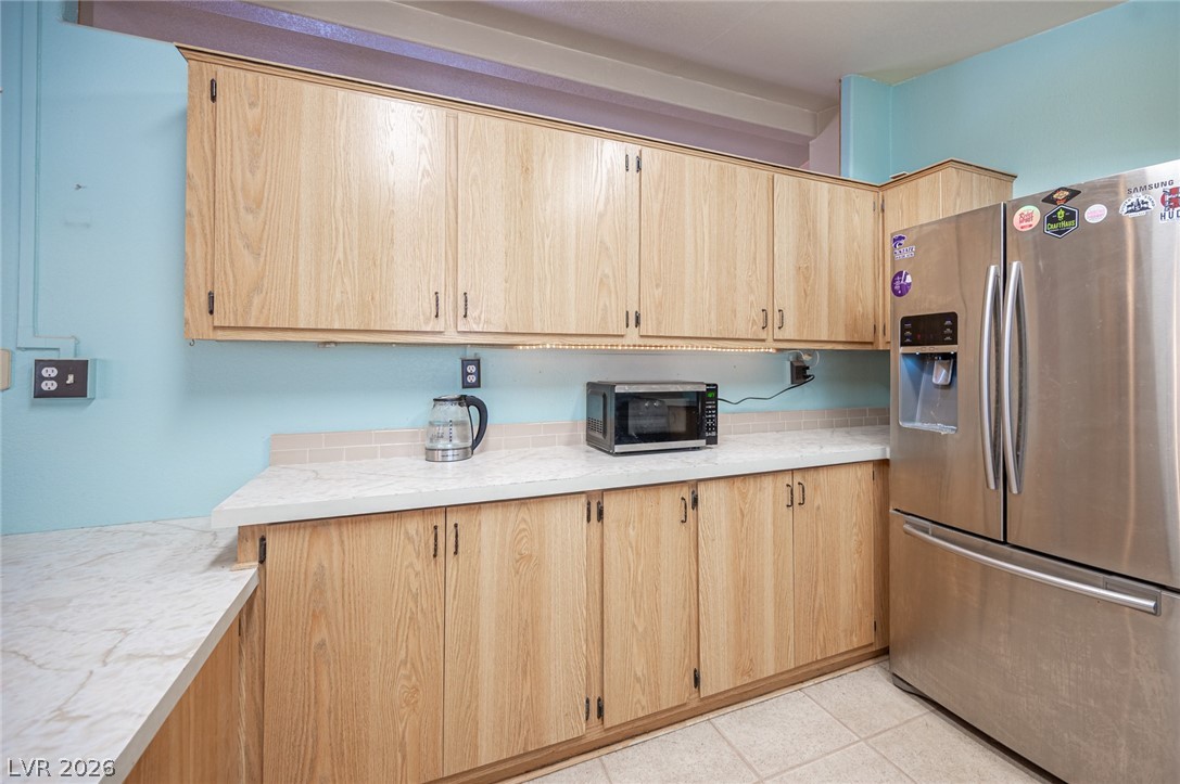 3200 Maple Road Pahrump, NV 89048 - Photo 18 of 53 Wood cabinetry with sleek stainless steel appliances anchors this practical kitchen space.