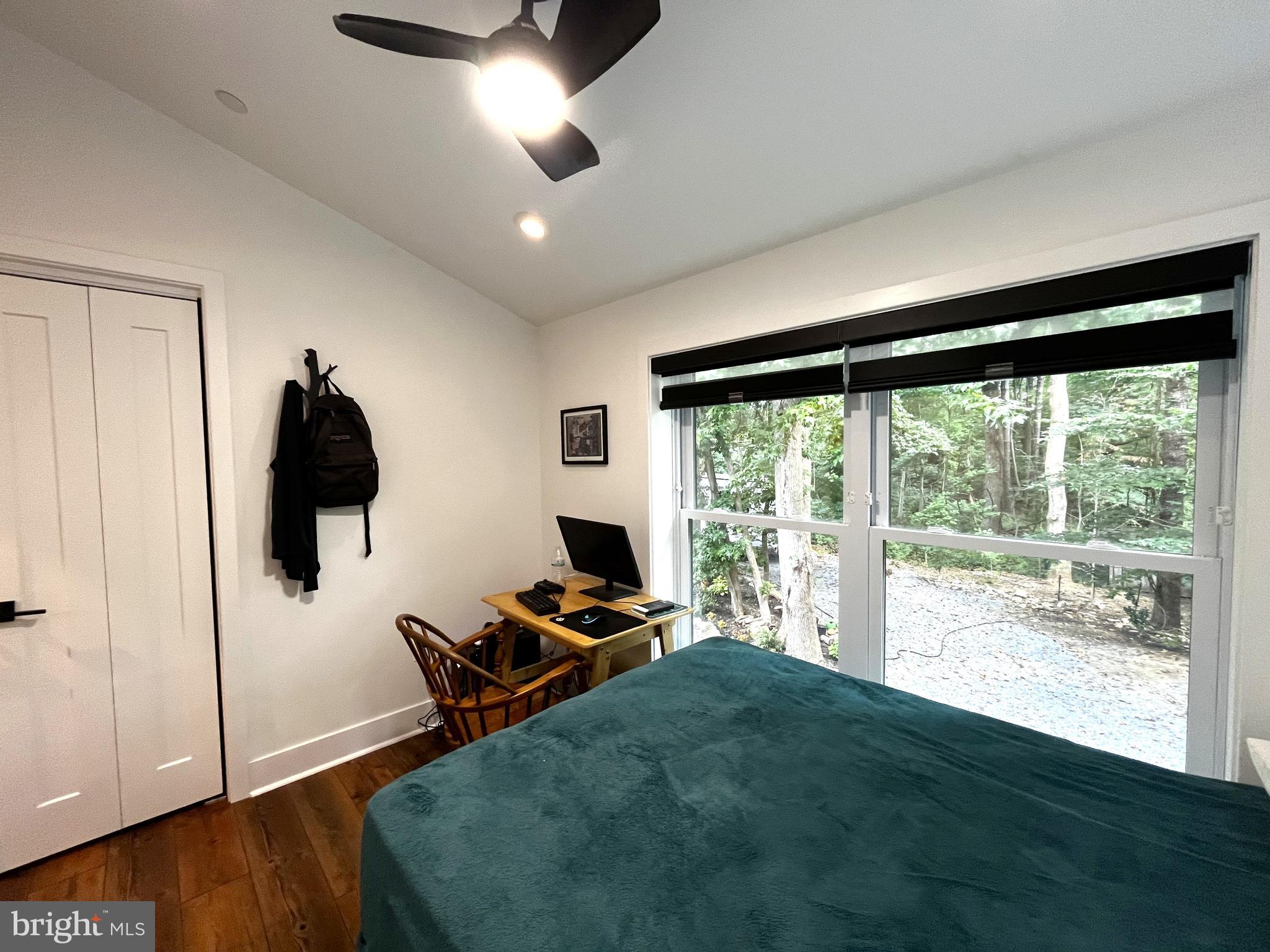 2020 Biglane Court, Unit A Huntingtown, MD 20639 - Photo 24 of 29 a living room with hardwood floor and a ceiling fan