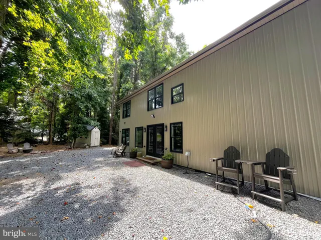 a backyard of a house with yard and outdoor seating