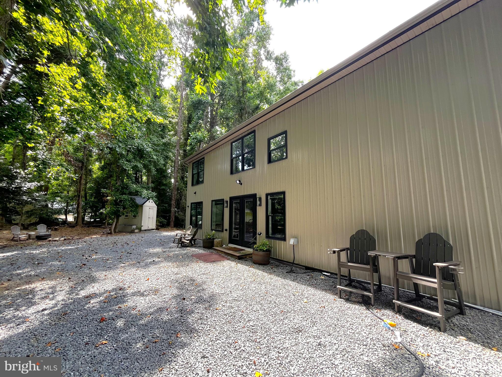 2020 Biglane Court, Unit A Huntingtown, MD 20639 - Photo 27 of 29 a backyard of a house with yard and outdoor seating