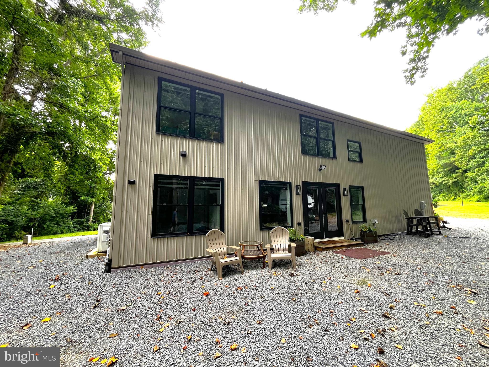 2020 Biglane Court, Unit A Huntingtown, MD 20639 - Photo 28 of 29 a view of a house with backyard and sitting area