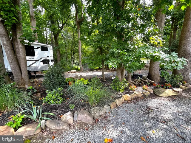 a backyard of a house with lots of green space and fountain view