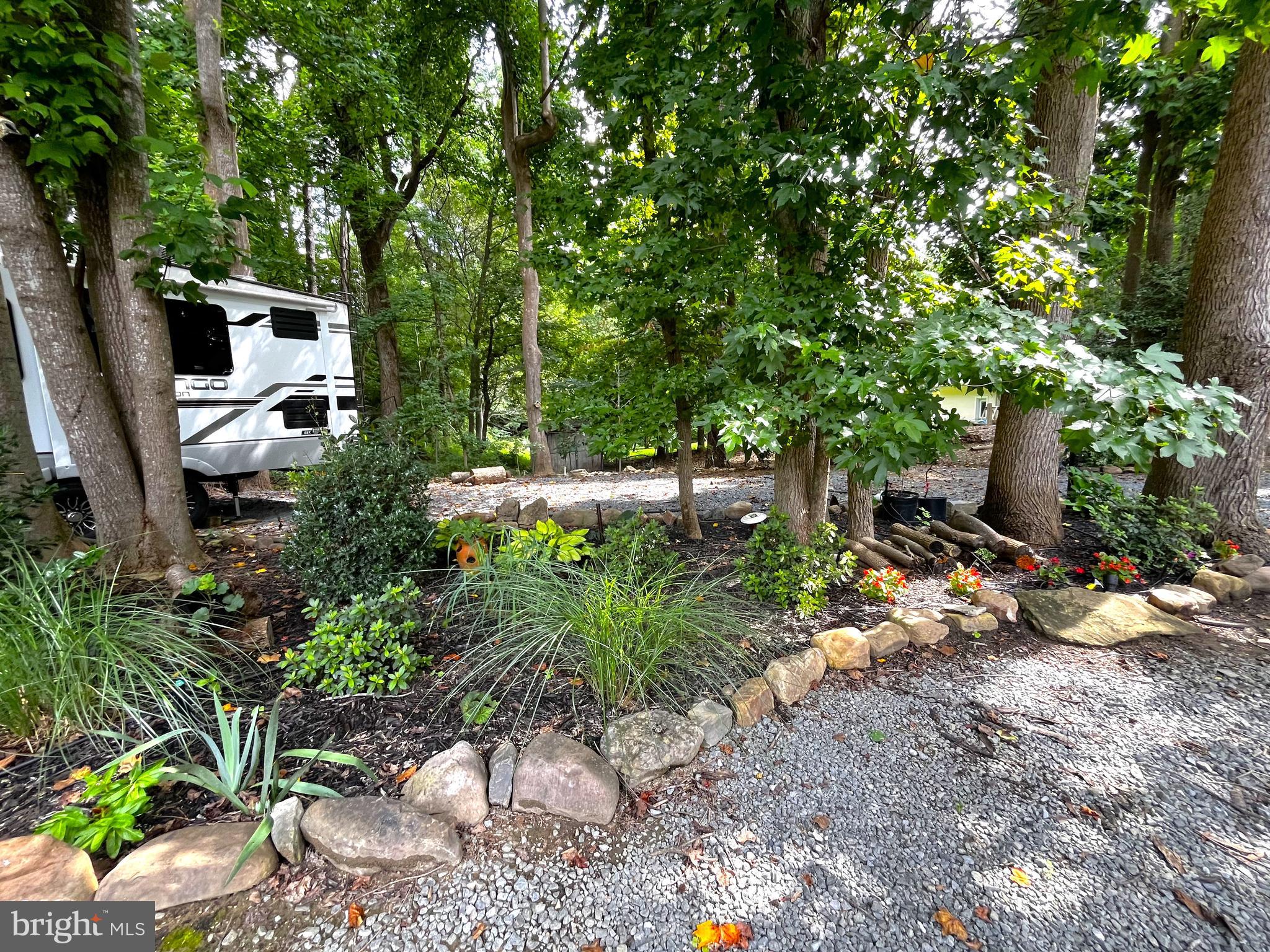 2020 Biglane Court, Unit A Huntingtown, MD 20639 - Photo 4 of 29 a backyard of a house with lots of green space and fountain view