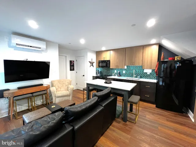 a kitchen with a table chairs refrigerator and a sink