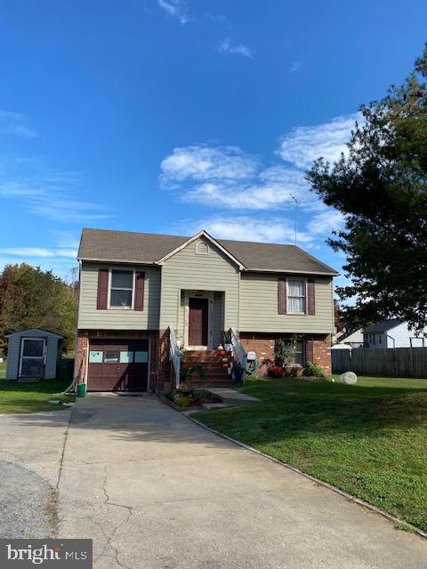 10633 Leavells Road Fredericksburg, VA 22407 - Photo 1 of 1 a front view of a house with a yard and garage