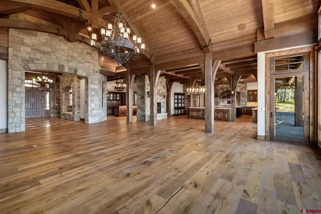 a room with lots of wooden furniture and a fireplace