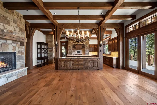 a kitchen with a stove a counter top space and a chandelier