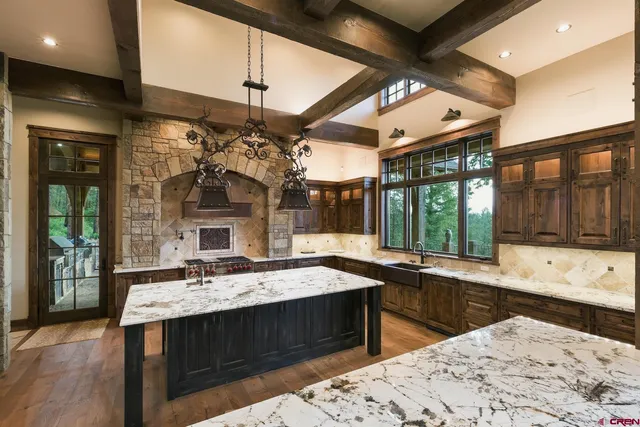 a kitchen with stainless steel appliances granite countertop a stove and a sink