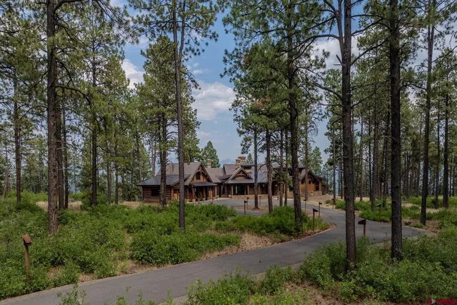 a view of a house with a yard and sitting area
