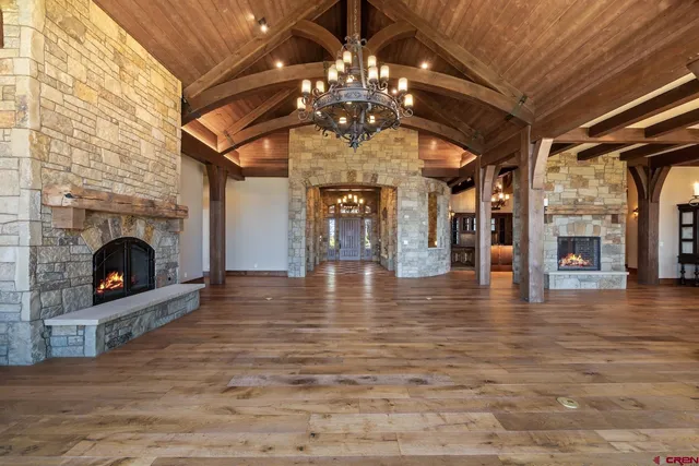 a view of an entryway of a house with a floor to ceiling window and wooden floor