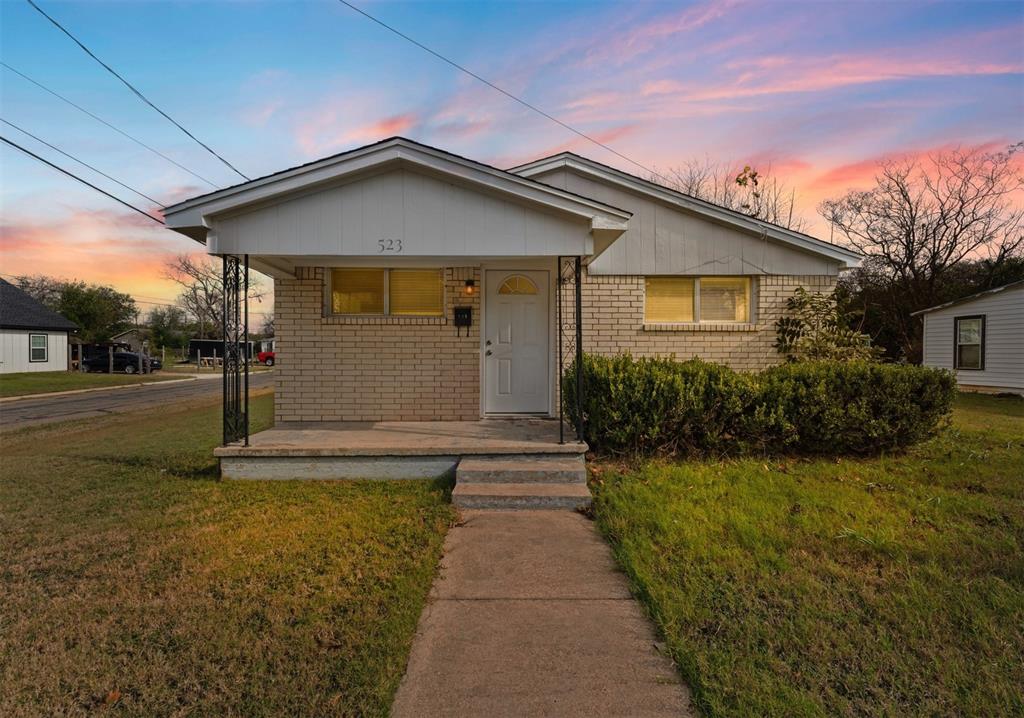 a front view of house with yard and green space