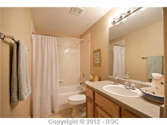 8739 Del Rio Road Peyton, CO 80831 - Photo 20 of 25 The basement has a full Finished Bath w/a hickory vanity, single sink, mirror and tub/shower w/ tile surround.