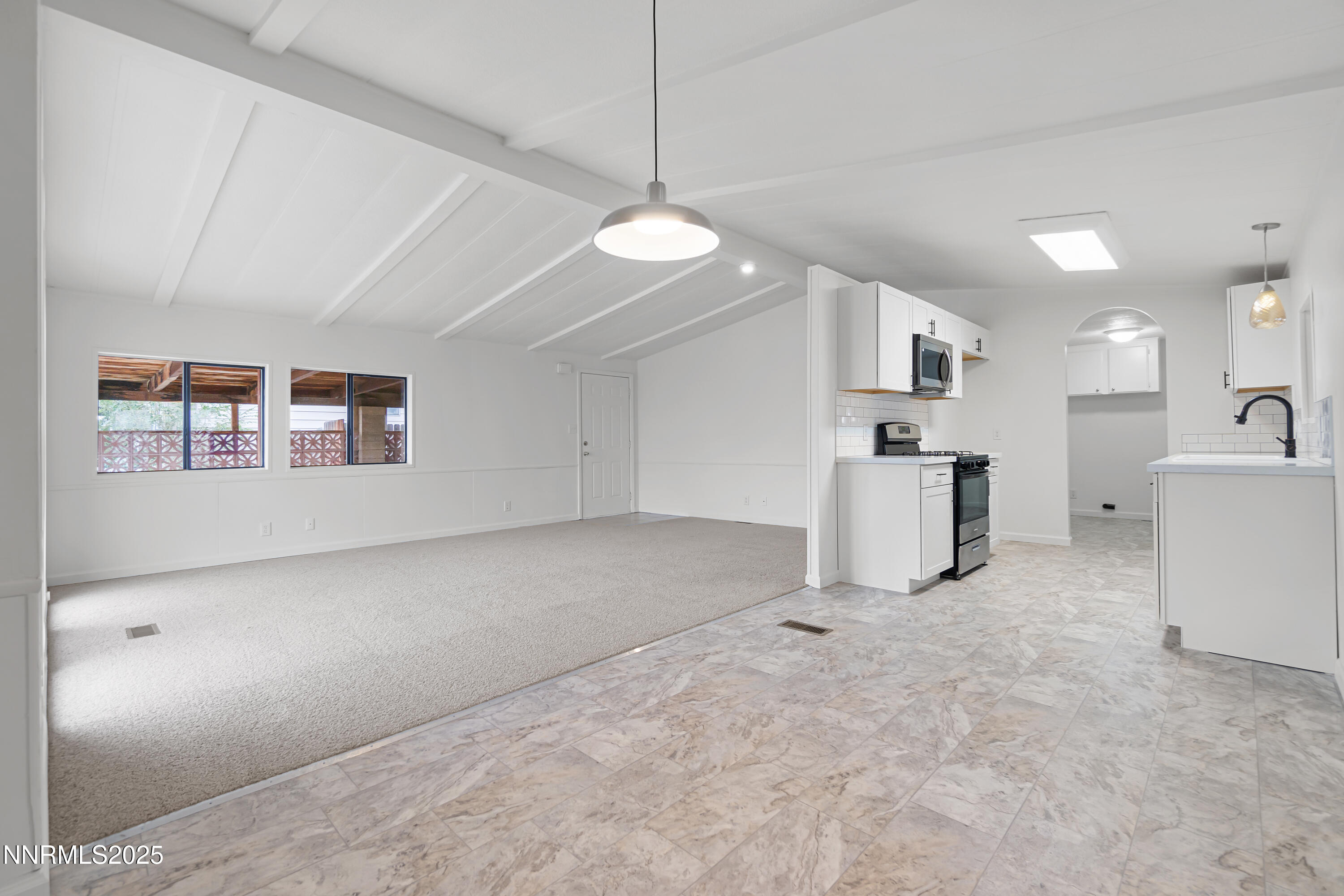 1025 Villa Way Fernley, NV 89408 - Photo 12 of 26 a view of a kitchen with furniture and a ceiling fan