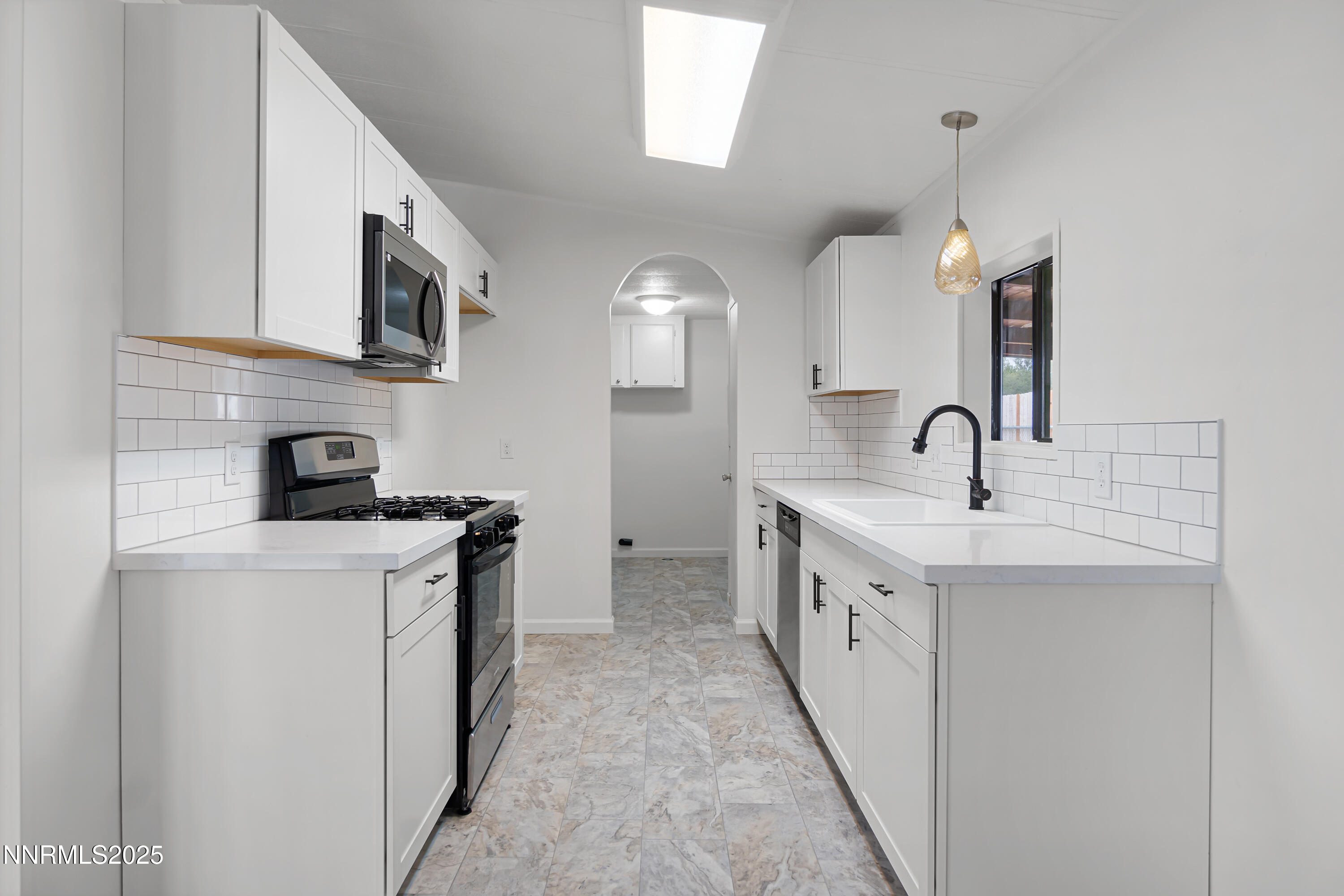 1025 Villa Way Fernley, NV 89408 - Photo 13 of 26 a kitchen with a sink and a stove top oven