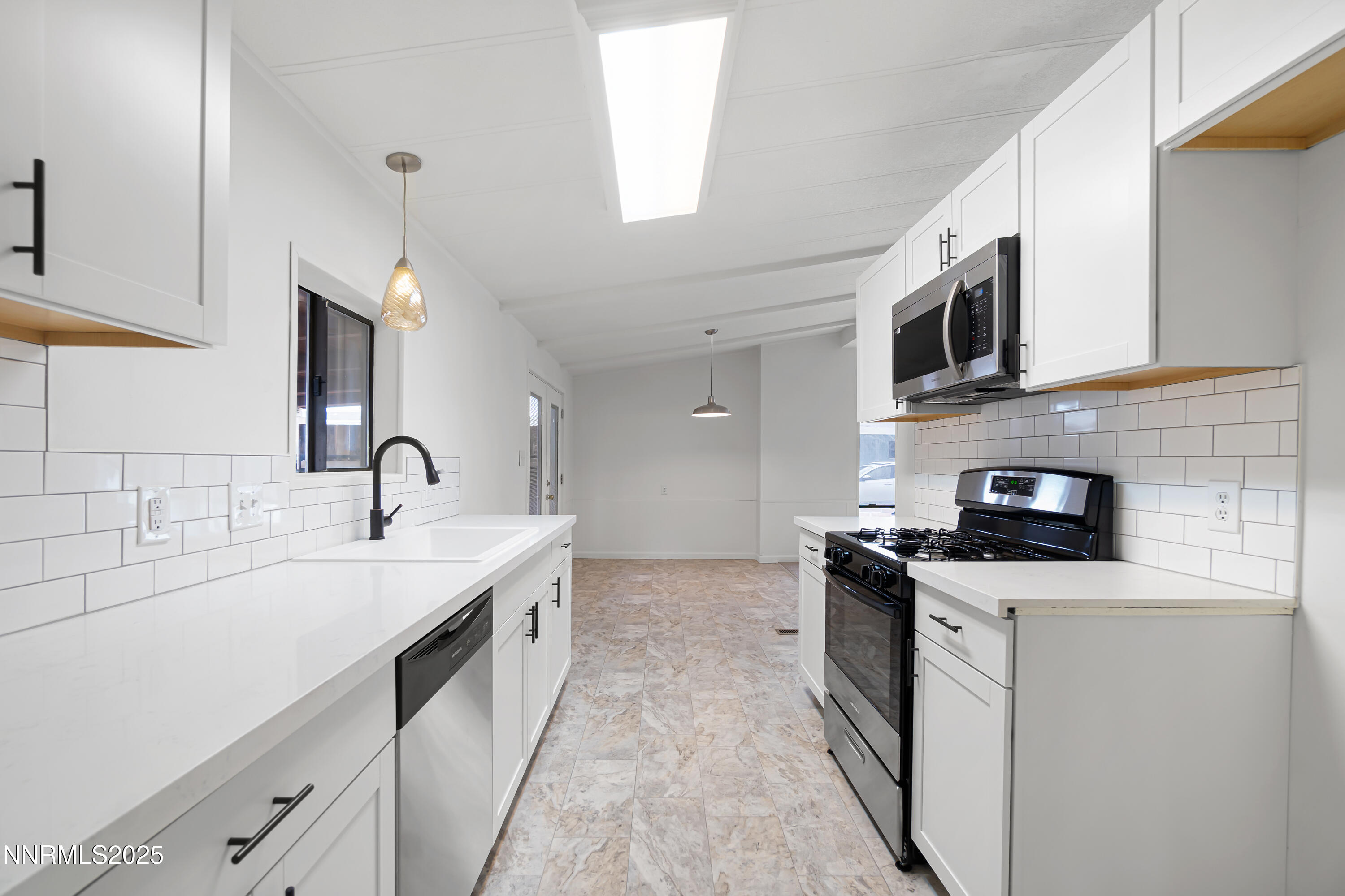 1025 Villa Way Fernley, NV 89408 - Photo 16 of 26 a kitchen with stainless steel appliances granite countertop a sink stove oven and microwave