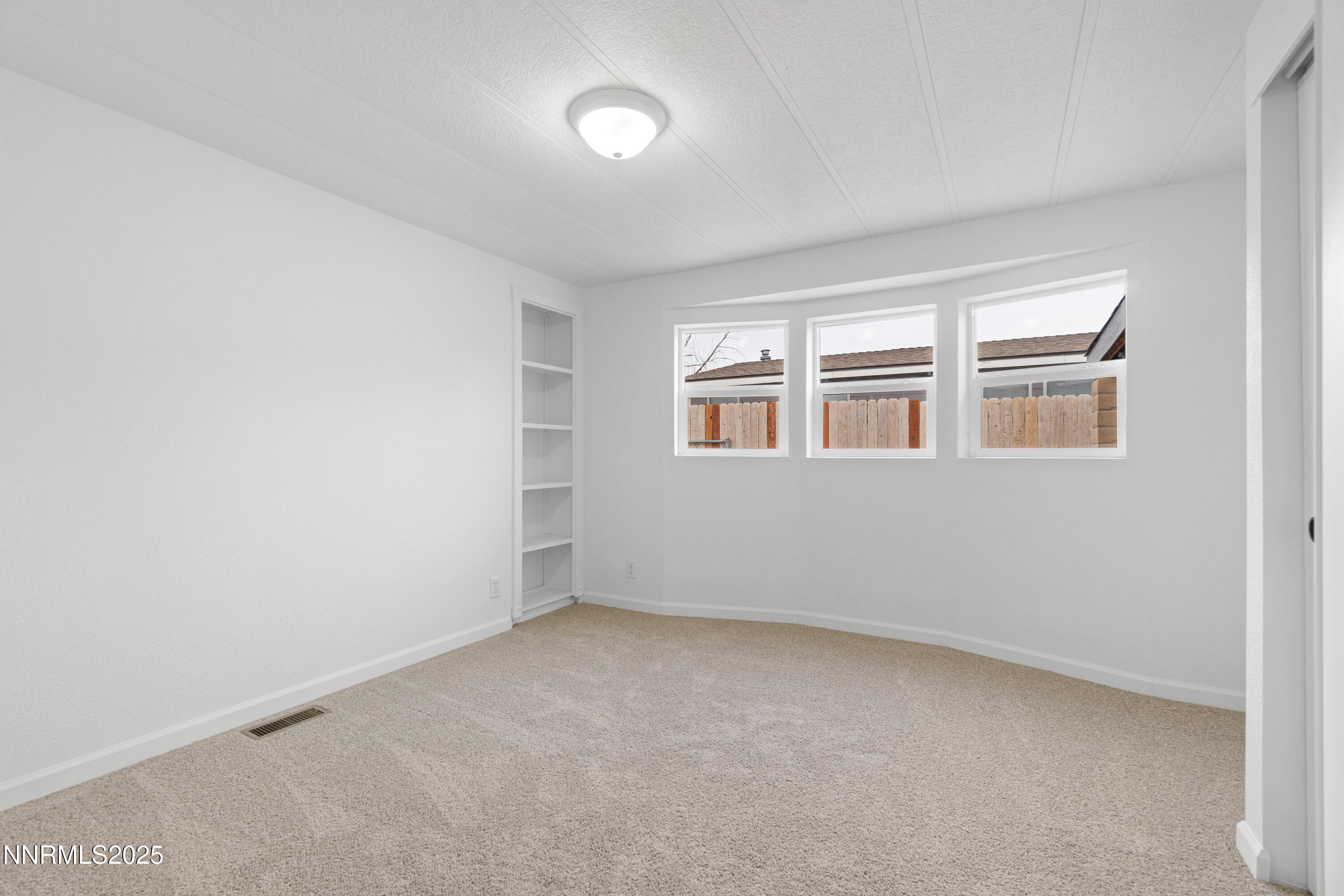1025 Villa Way Fernley, NV 89408 - Photo 21 of 26 an empty room with windows