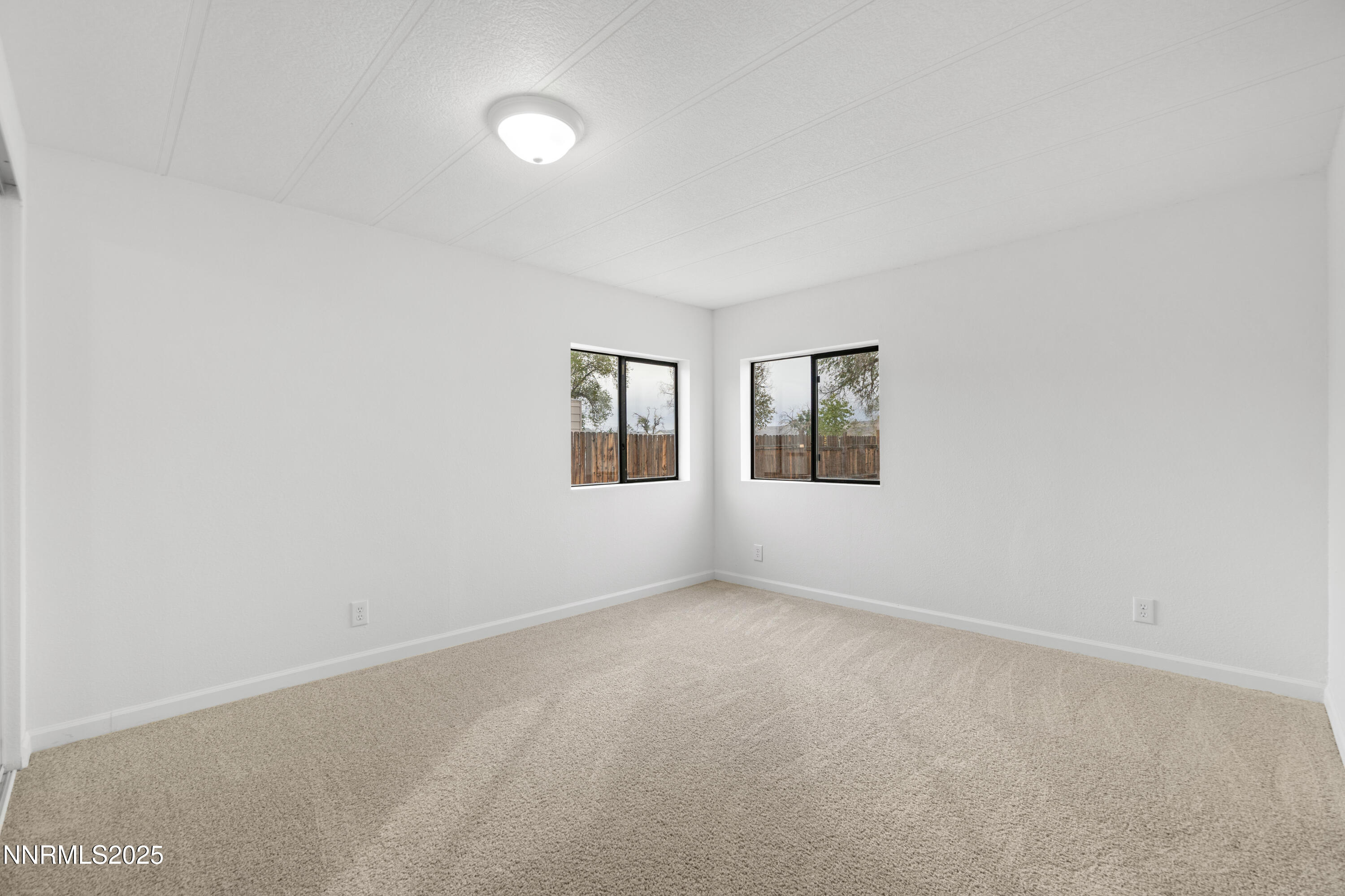 1025 Villa Way Fernley, NV 89408 - Photo 23 of 26 an empty room with windows