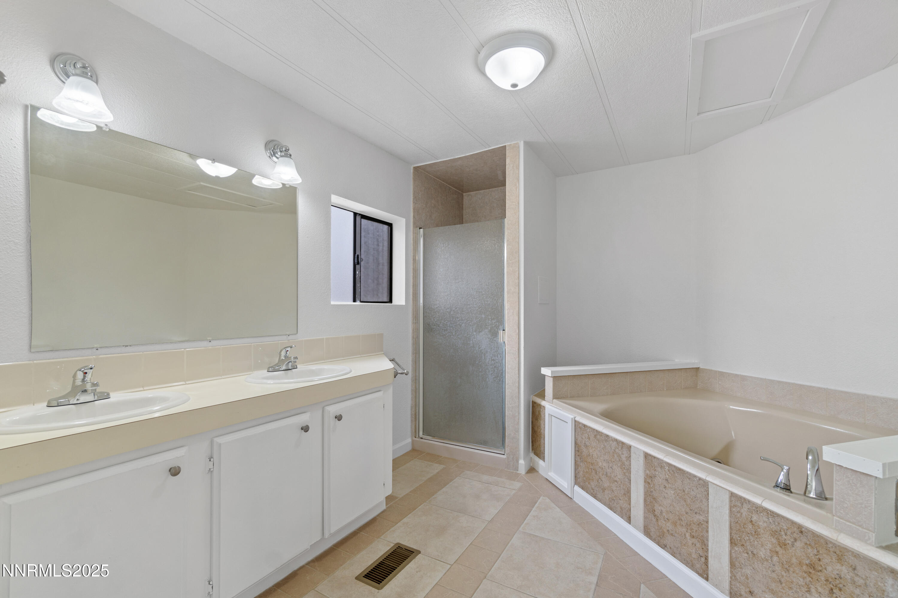 1025 Villa Way Fernley, NV 89408 - Photo 25 of 26 a spacious bathroom with a tub sink and mirror