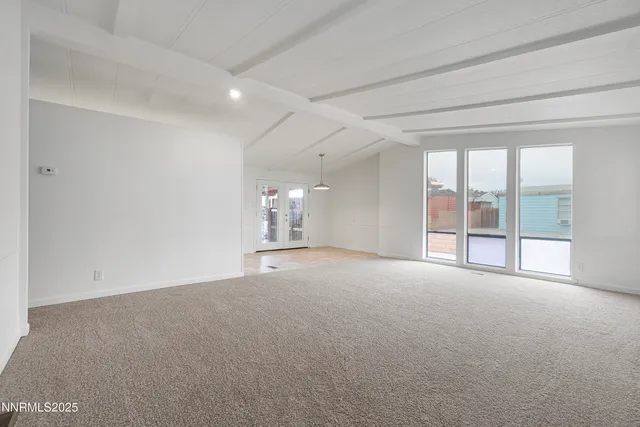 a view of a kitchen with furniture and a ceiling fan