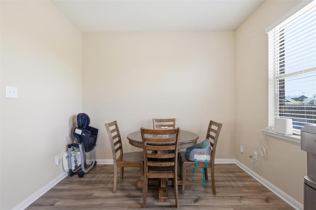 292 Wandering Stream Way Princeton, TX 75407 - Photo 15 of 40 Dining area with wood finished floors and baseboards