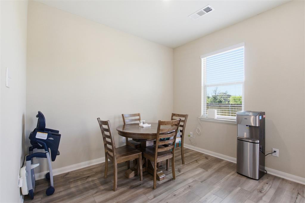 292 Wandering Stream Way Princeton, TX 75407 - Photo 16 of 40 Dining area with light wood finished floors and baseboards