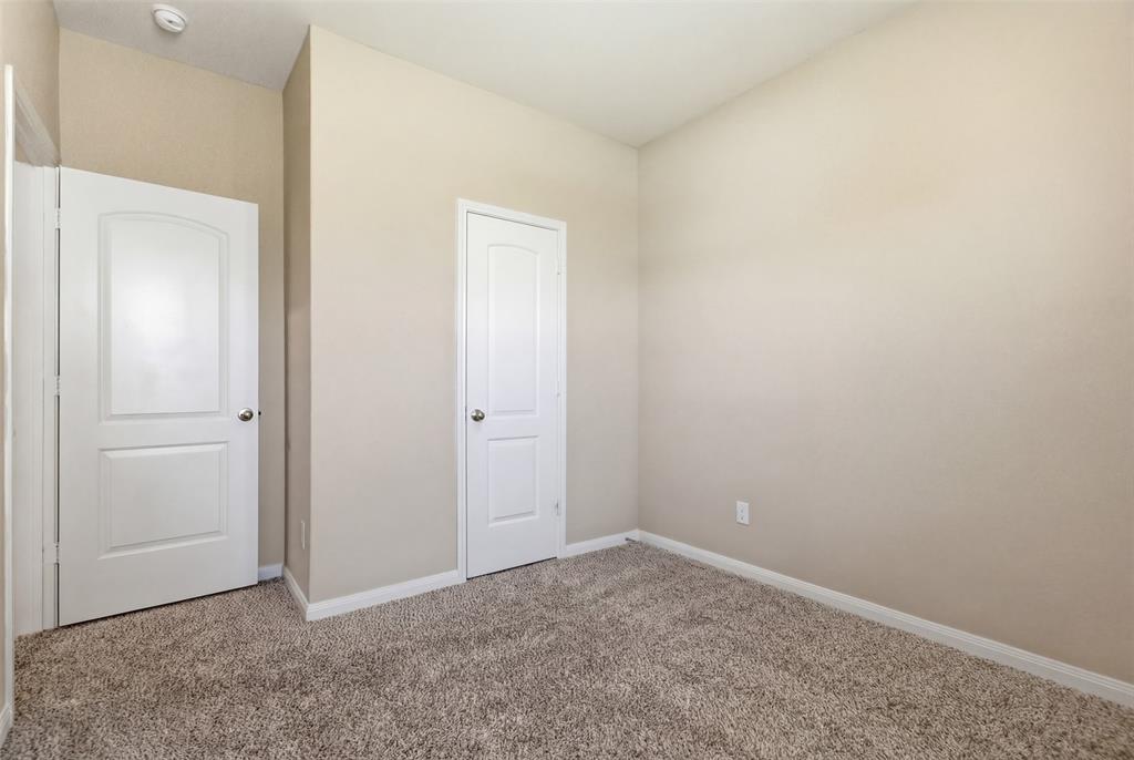 292 Wandering Stream Way Princeton, TX 75407 - Photo 18 of 40 Unfurnished bedroom featuring baseboards and light carpet