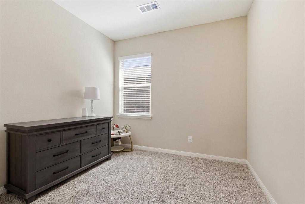 292 Wandering Stream Way Princeton, TX 75407 - Photo 21 of 40 Bedroom with baseboards and light carpet