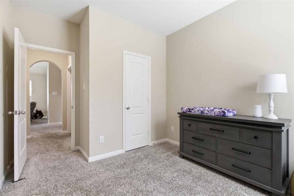 292 Wandering Stream Way Princeton, TX 75407 - Photo 22 of 40 Bedroom with arched walkways and light colored carpet