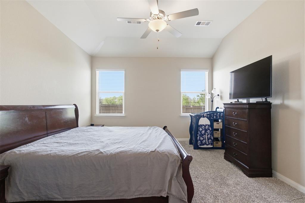 292 Wandering Stream Way Princeton, TX 75407 - Photo 25 of 40 Bedroom with light colored carpet, vaulted ceiling, and ceiling fan