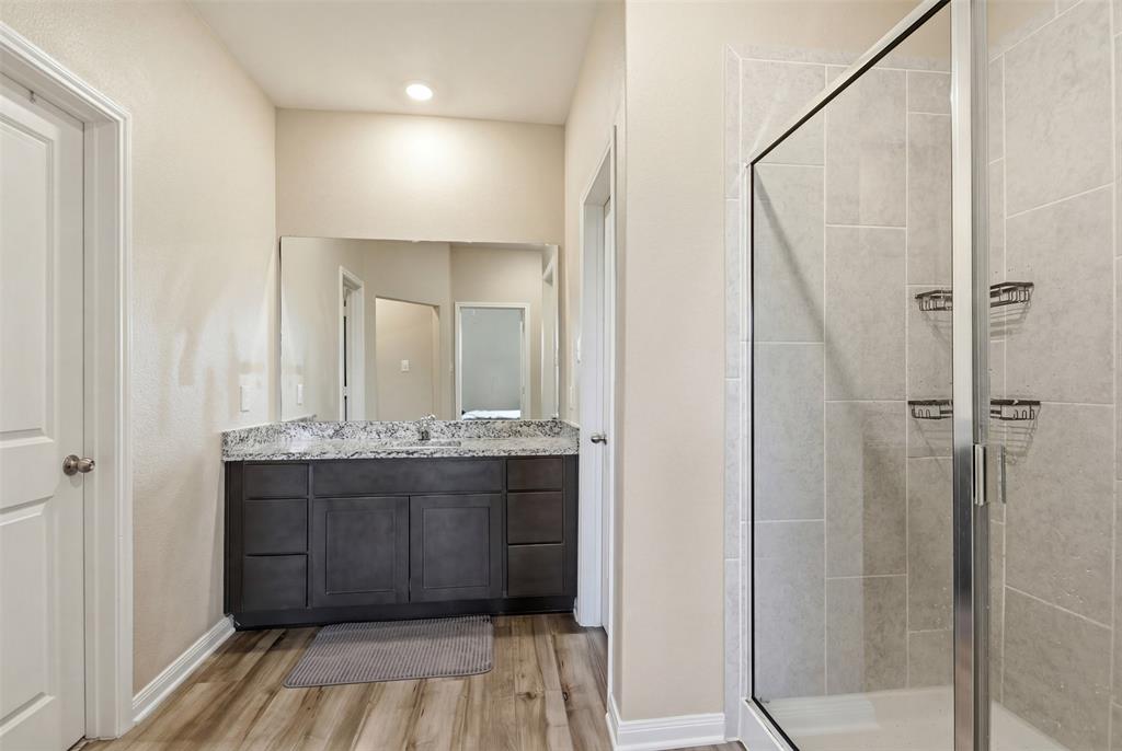 292 Wandering Stream Way Princeton, TX 75407 - Photo 27 of 40 Bathroom featuring vanity, a stall shower, and light wood finished floors