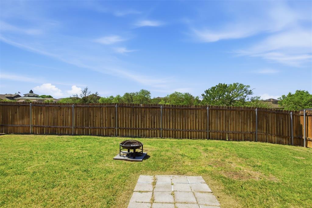 292 Wandering Stream Way Princeton, TX 75407 - Photo 31 of 40 Fenced backyard featuring a fire pit and a patio