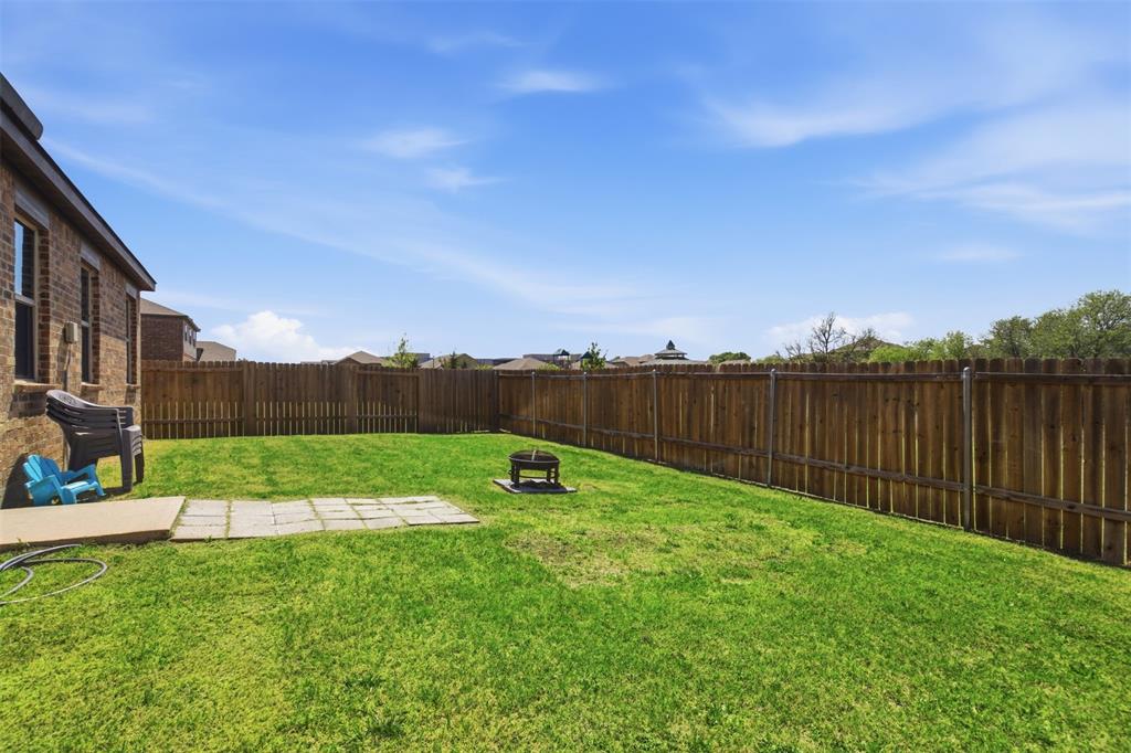 292 Wandering Stream Way Princeton, TX 75407 - Photo 32 of 40 Fenced backyard with a patio and an outdoor fire pit