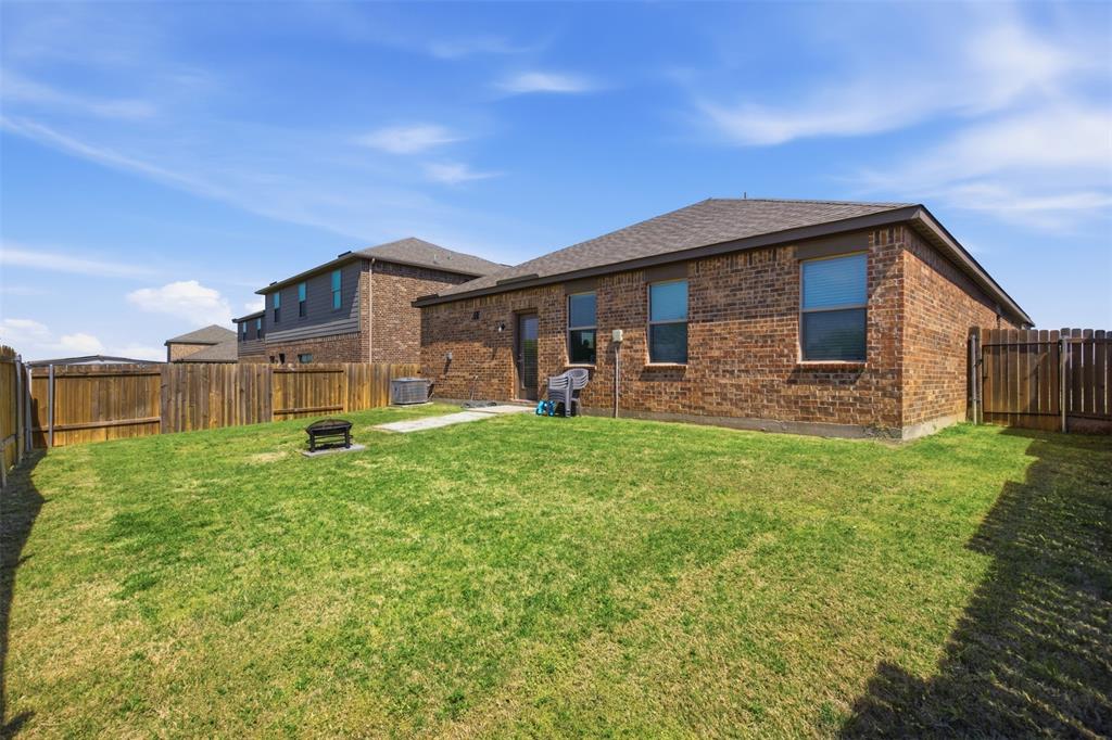 292 Wandering Stream Way Princeton, TX 75407 - Photo 34 of 40 Back of house with a fenced backyard, brick siding, a patio area, and a shingled roof