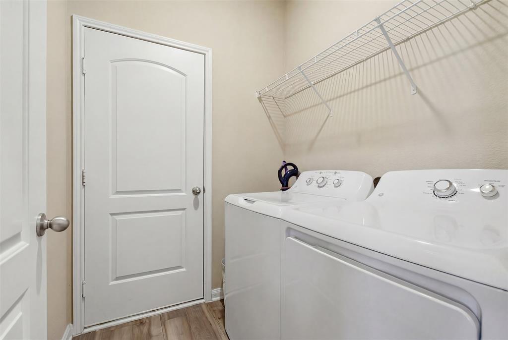 292 Wandering Stream Way Princeton, TX 75407 - Photo 38 of 40 Laundry room featuring washer and dryer and light wood-style floors