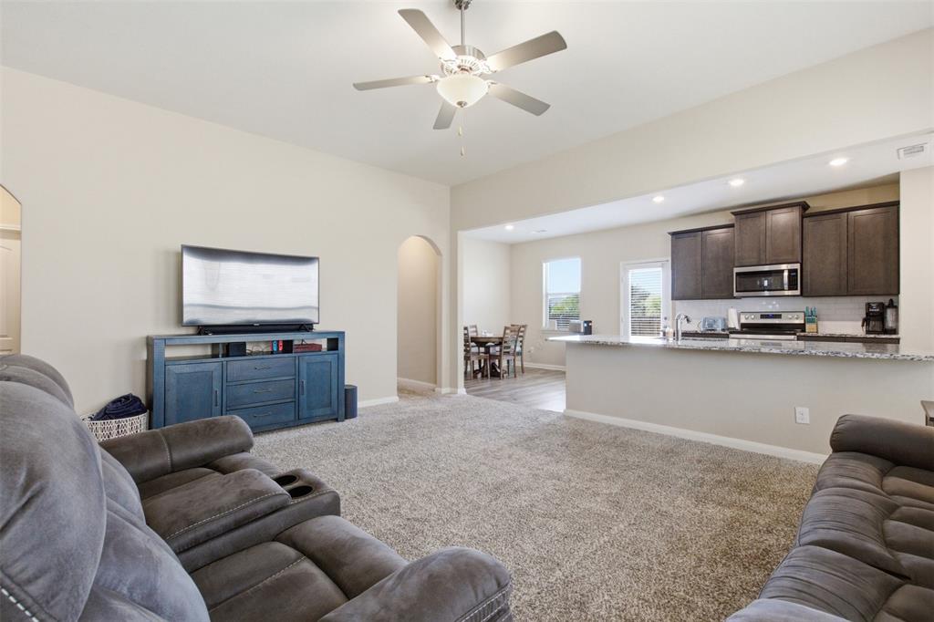 292 Wandering Stream Way Princeton, TX 75407 - Photo 8 of 40 Living room featuring arched walkways, light carpet, ceiling fan, and recessed lighting