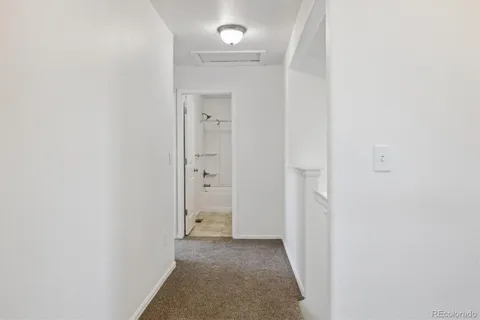 a view of a hallway with white walls