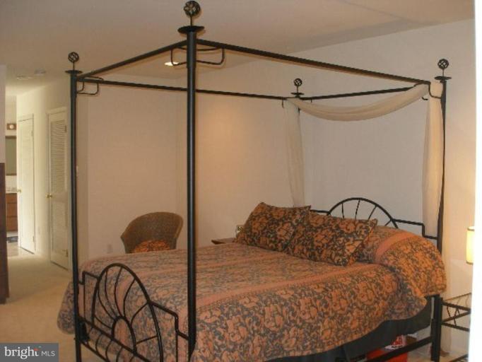1324 Pine Tree Road McLean, VA 22101 - Photo 16 of 23 a bedroom with a bed a chandelier and a window