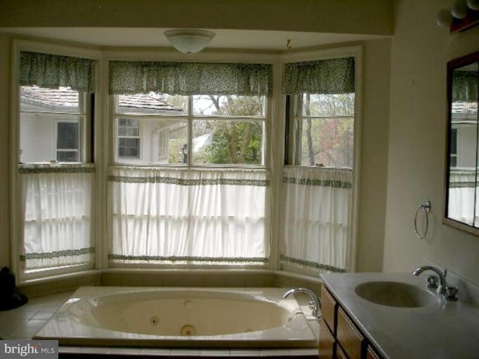 1324 Pine Tree Road McLean, VA 22101 - Photo 18 of 23 a view of a bathroom with tub and window