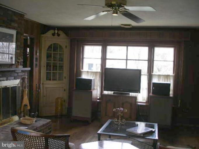 1324 Pine Tree Road McLean, VA 22101 - Photo 10 of 23 a living room with furniture a flat screen tv and a floor to ceiling window